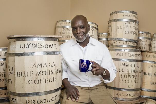 man holding a cup of jamaican blue mountain coffee cup 