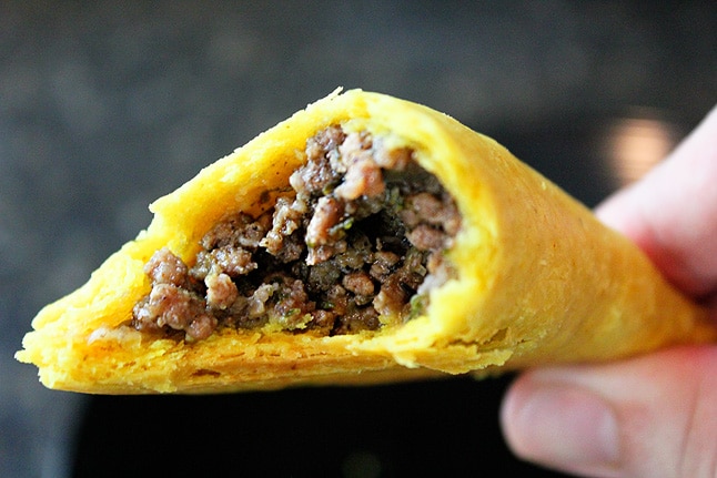 a half eaten jamaican beef pattie