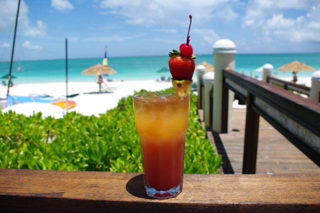 a glass of jamaican rum punch on the beach