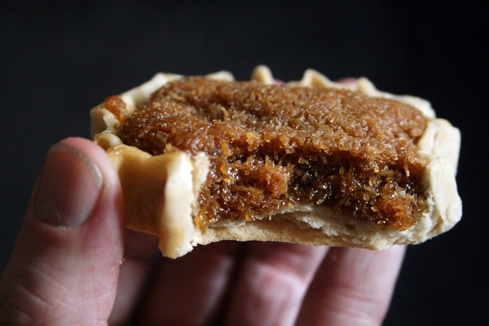 eating gizzada tart, one of the Jamaican wedding traditions