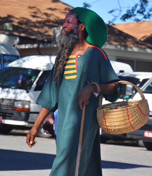 Rastafarian man carrying a basket